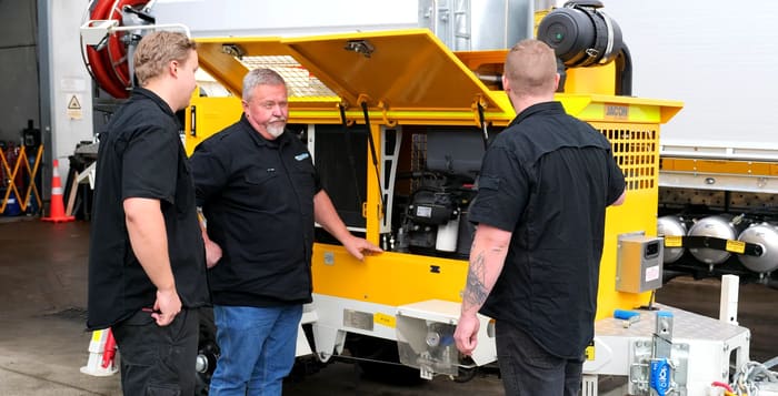 PS Equipment team reviewing a concrete trailer pump